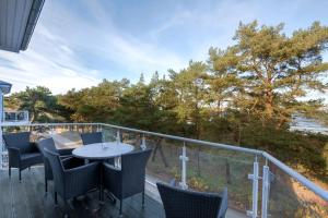 a patio with chairs and a table on a deck at Ostseeresidenz Gorki- Park - 20 mit Wellness und Schwimmbad in Bansin
