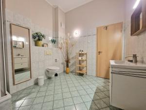 a bathroom with a toilet and a sink and a mirror at Bella Vita in Trassenheide