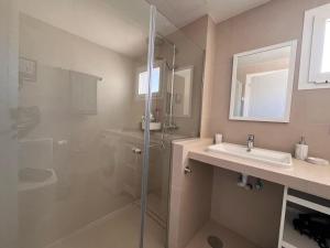 a bathroom with a shower and a sink at Villa Majunaxa in Corralejo +9 photos