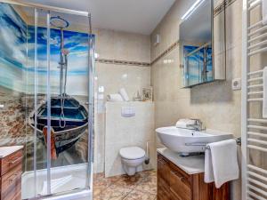 a bathroom with a shower and a toilet and a sink at Villa Bellevue App. 8 in Ahlbeck