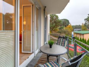 a patio with a table and chairs on a balcony at Ferienwohnung Eichhorst in Trassenheide