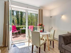 ein Wohnzimmer mit einem Tisch und Stühlen sowie eine Terrasse in der Unterkunft Hansehus Ferienwohnung Nr 3 in Zinnowitz