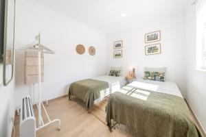 Katil atau katil-katil dalam bilik di Assenta Beach House - T2