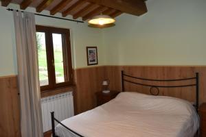 Postel nebo postele na pokoji v ubytování Agriturismo Le Ginestre