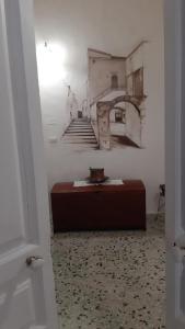 a room with a bed and stairs in the background at residence specchia in Specchia