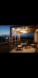un patio con panche e tavoli su un balcone di notte di Appartement contemporain lumineux avec terrasse a Vitré