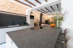 a kitchen with a large marble counter top and a fireplace at Casa Adela - Luxury Rural Accommodation in Castellonet
