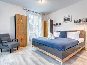 a bedroom with a bed and a chair at Ostseeresidenz Gorki- Park - 05 mit Wellness und Schwimmbad in Bansin