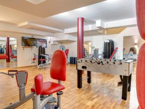 a gym with a ping pong table and red chairs at Ostseeresidenz Gorki- Park - 05 mit Wellness und Schwimmbad in Bansin