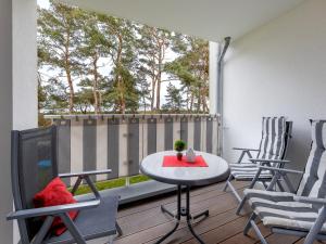a patio with a table and chairs on a deck at Ostseeresidenz Gorki- Park - 03 mit Wellness und Schwimmbad in Bansin