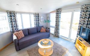a living room with a couch and a tv at MP261 Parkdean Camber Sands in Camber