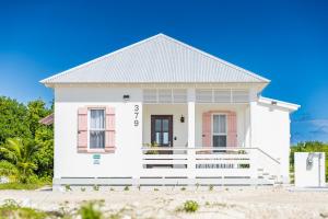 a white house on the beach at Casa Playa de Denver + Pool Club at Mahogany Bay in San Pedro