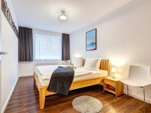 a hotel room with a bed and a window at Villa Madeleine KU 08 in Bansin +11 photos