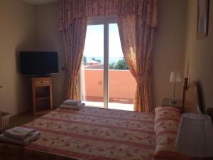 a bedroom with a television and a bed at Marbella Beach Resort at Club Playa Real in Marbella