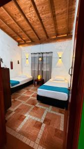 a bedroom with two beds in a room at Cabaña ideal 5-9 personas cocina, wifi, cerca al parque y campestre in Jardin +49 photos