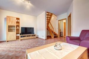 a living room with a couch and a tv at Ferienhaus "Krabbe" in Ostseebad Karlshagen