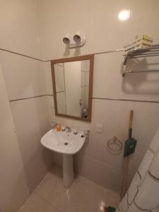 a small bathroom with a sink and a mirror at Deptos de Lili in Termas de Río Hondo