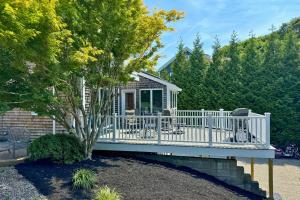 a house with a white deck and a tree at Walk to Beach! Hyannis Family Haven w/ Deck in Hyannis