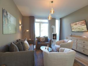 a living room with two couches and a couch at Ferienhaus Reethus 54° Loddin in Loddin