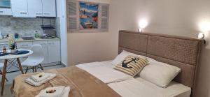 a bed in a small room with a kitchen at Apartment Cattaro magico in Kotor