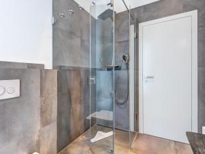 a shower with a glass door in a bathroom at Ferienhaus Rosa in Ostseebad Karlshagen