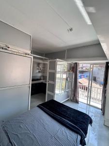 a bedroom with a bed in a room with a window at The Lavish Residency in Panchgani