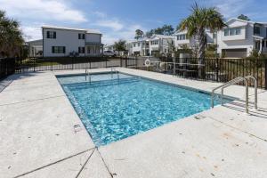 a swimming pool in a yard with houses at Bay Breeze Retreat in Orange Beach
