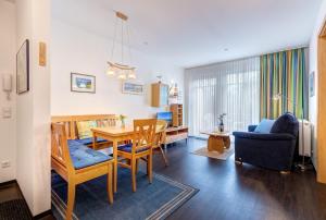 a living room with a table and a dining room at Schloonseevillen FeWo 17 in Bansin