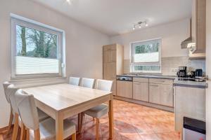 a kitchen with a wooden table and chairs at Ferienhaus "Seestern" in Karlshagen