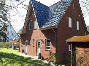 a large red brick house with a solar roof at Ferienhaus "Seestern" in Karlshagen