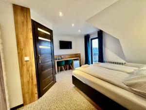 Pokój hotelowy z łóżkiem i biurkiem w obiekcie Pod Sosnami Termy 450m -20 procent na Termy w Białym Dunajcu