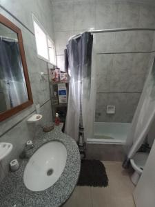 a bathroom with a sink and a shower at Deptos de Lili 2 in Termas de Río Hondo