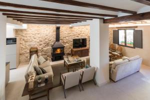 a living room with a stone wall at Casa Adela - Luxury Rural Accommodation in Castellonet