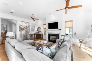 a living room with a couch and a fireplace at Sand On Tap in Inlet Beach