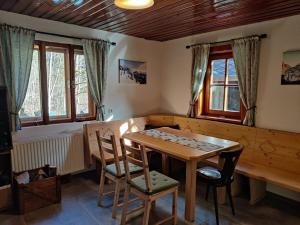 a dining room with a wooden table and chairs at Idyllic Mountain Hütte -Gesäuse Nationalpark in Landl