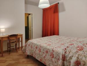 フォリーニョにあるcasaRegina b&b in collinaのベッドと机とテーブルのある寝室