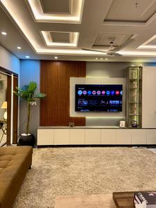 a living room with a large flat screen tv at Luxury kanal portion in Islamabad in Islamabad