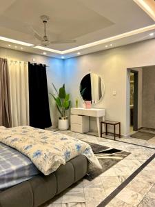 a bedroom with a large bed and a mirror at Luxury kanal portion in Islamabad in Islamabad