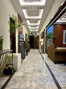 a lobby with couches and plants in a building at Luxury kanal portion in Islamabad in Islamabad +44 photos