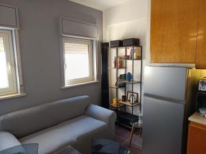 a living room with a couch and a refrigerator at D&P Apartments Suite 3 Salemi in Salemi