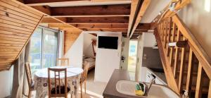 a small kitchen with a table and a kitchen with wooden ceilings at Appartement à la Trinité sur Mer in La Trinité-sur-Mer