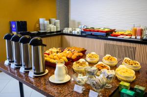 a buffet of food on a table in a restaurant at Nordeste Palace Hotel - Fortaleza in Fortaleza