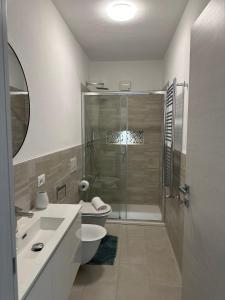 a bathroom with a shower and a toilet and a sink at Beautiful Apartment with Swimming Pool in Olbia +11 photos