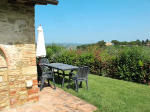 a patio with a table and chairs on the grass at Holiday Home Linearis K by Interhome in SantʼAppiano
