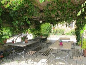 a group of tables and chairs under a pergola at Holiday Home Linearis K by Interhome in SantʼAppiano