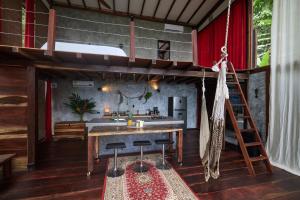 a kitchen and living room with a loft bed at villaseñoritaincognita in Minca