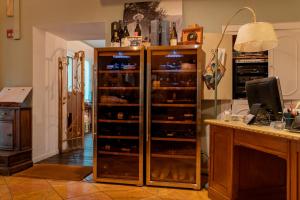 a large wooden cabinet filled with lots of wine bottles at Locanda Gaudemus Boutique Hotel in Sistiana