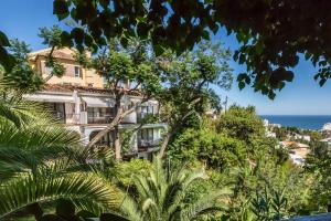 an apartment building on a hill with trees at Boutique Hotel Las Islas in Fuengirola