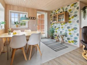 a dining room with a table and chairs at Holiday Home Uddi - 1-3km from the sea by Interhome in Fanø +19 photos