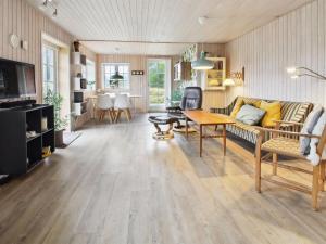 a living room with a couch and a table at Holiday Home Uddi - 1-3km from the sea by Interhome in Fanø